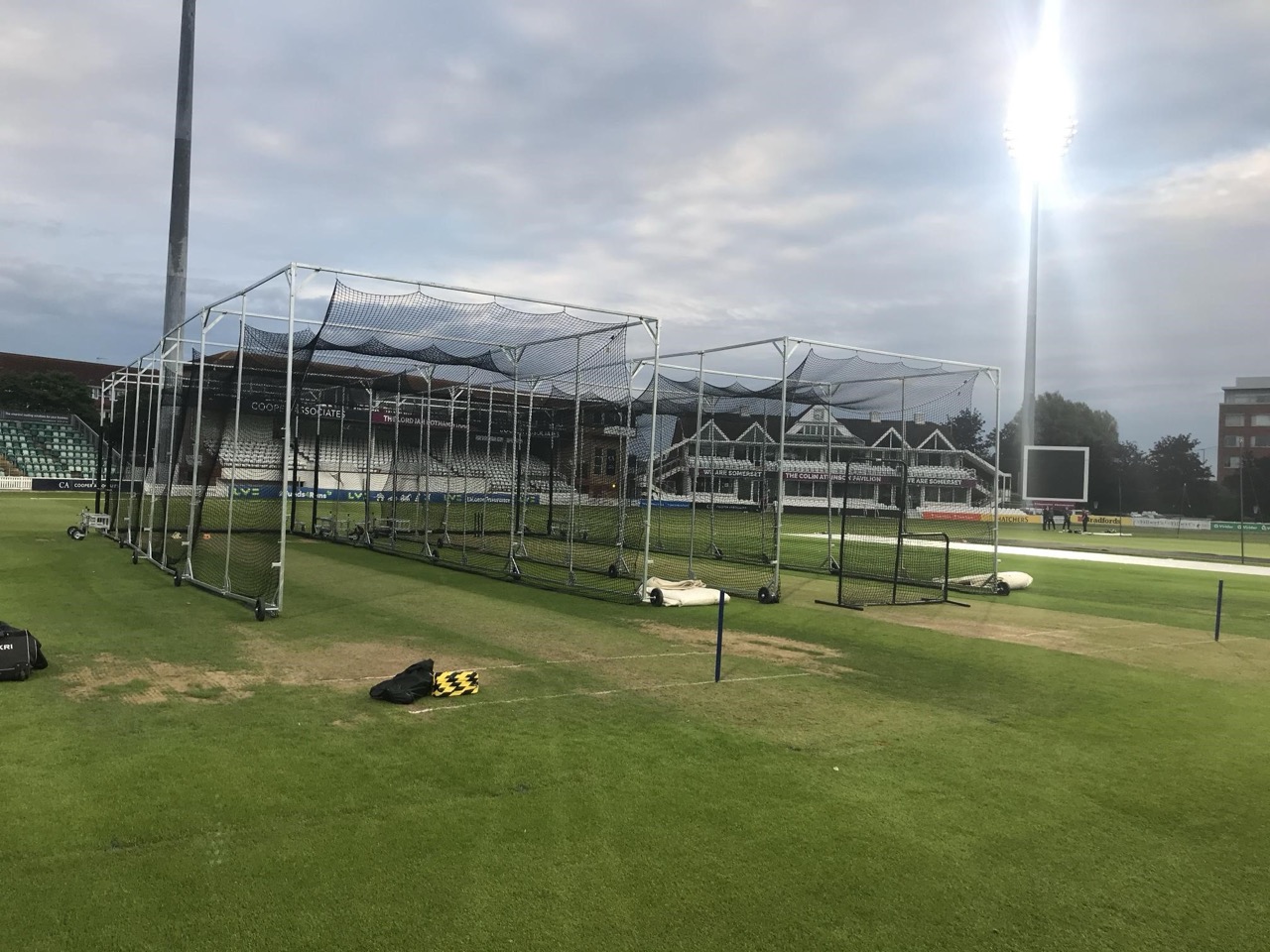 Professional cricket practice cages assembled on a stadium ground under floodlights, used for training and matches with Batting Cages Australia cages.