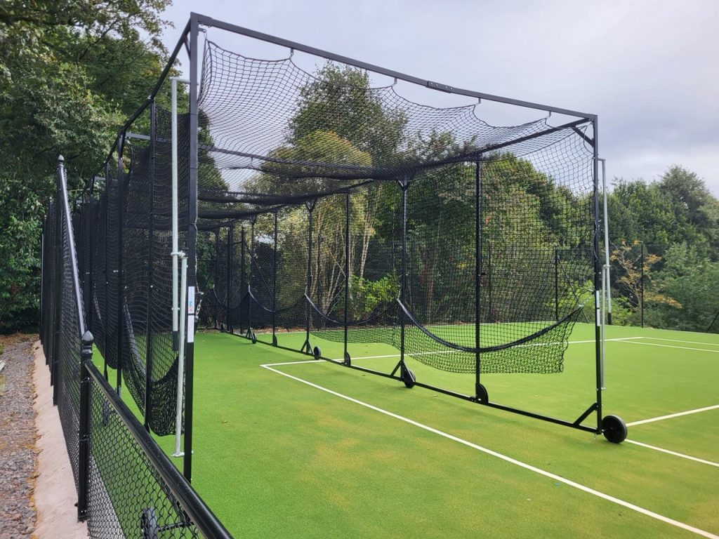 Portable cricket batting cage fully set up on synthetic green turf, designed by Batting Cages Australia for training use.