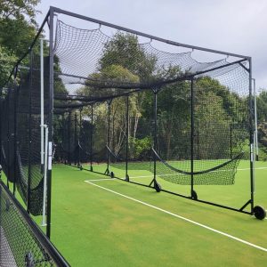 Portable cricket batting cage fully set up on synthetic green turf, designed by Batting Cages Australia for training use.